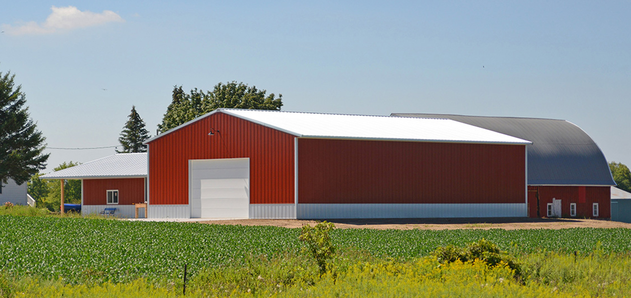 red and white post frame agricultural building and barn
